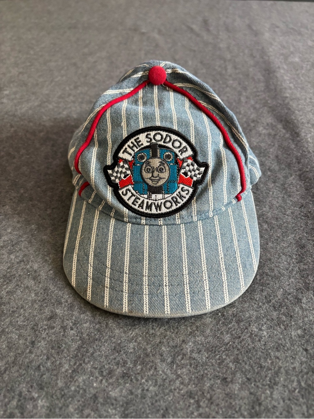 Kids Thomas the Tank Engine blue denim cap with white vertical stripes